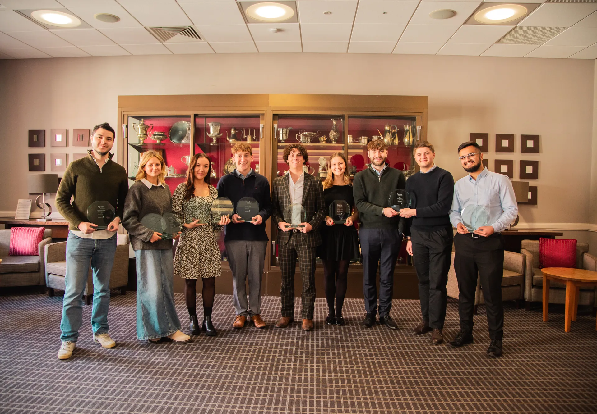 Spark award winners standing with their trophies